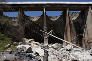 Rubble and a fallen pylon at the base of the dam