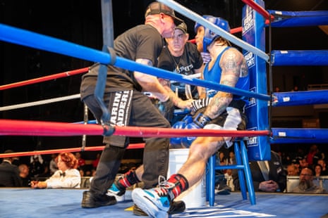 Reese Mistretta, right, takes instruction from his corner during Thursday’s fight: mother Desiree, center, and chief second Joe Higgins.