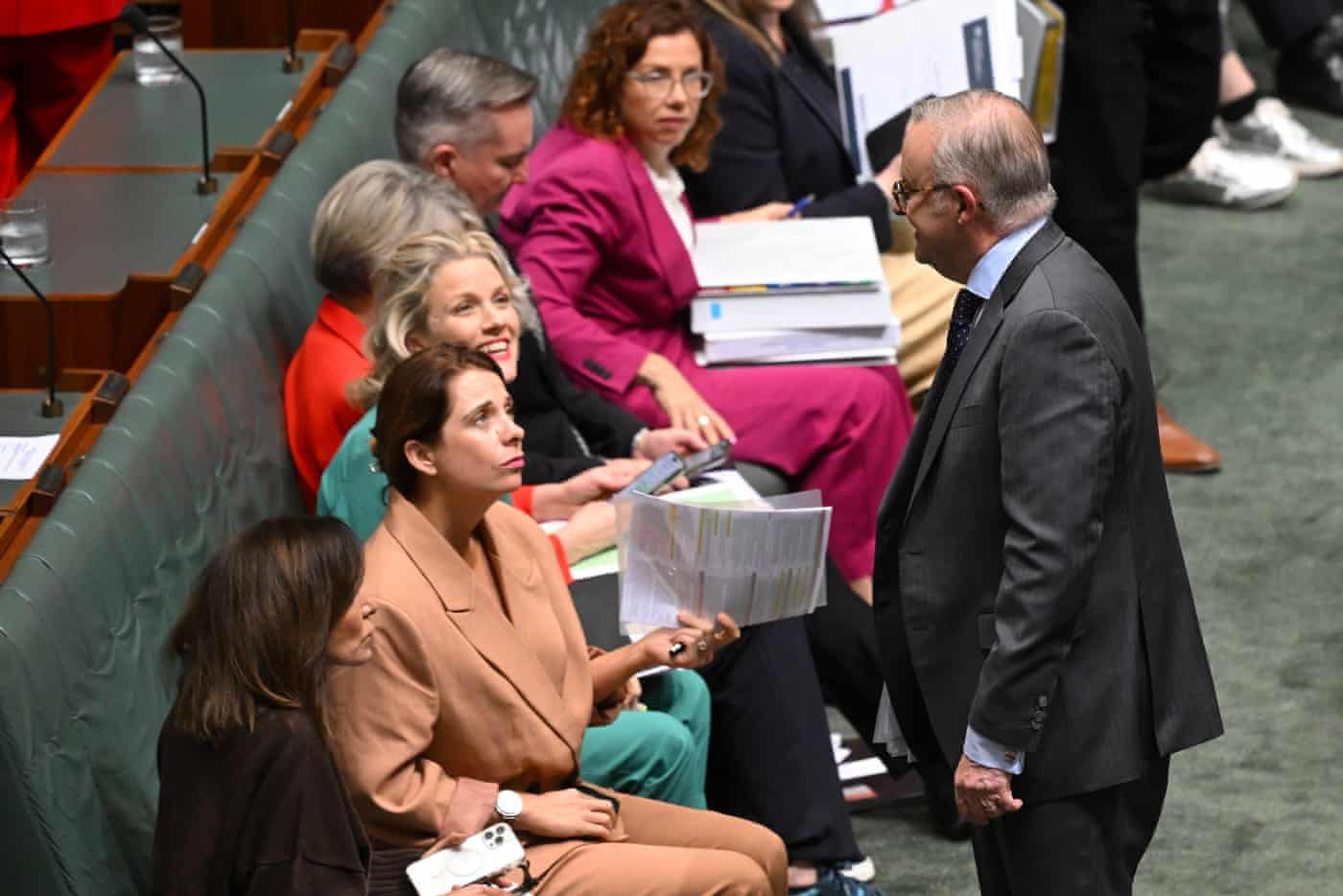 Anthony Albanese speaks to communications minsiter Anika Wells during question time on Wednesday.
