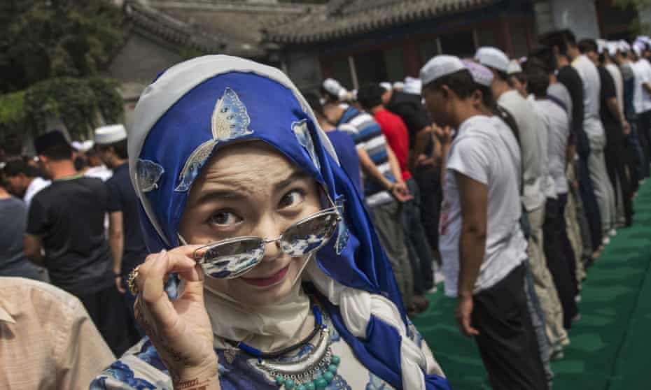 A Chinese Hui Muslim woman arrives for prayers at a Beijing mosque