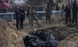 Russia-Ukraine war latest: fresh sanctions loom as Ukraine says more than 4,000 alleged war crimes being investigated – live | World news 1 People stand next to a mass grave in Bucha, on the outskirts of Kyiv, Ukraine.