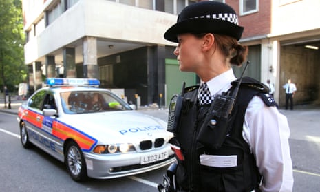 Woman police officer standing next to police car