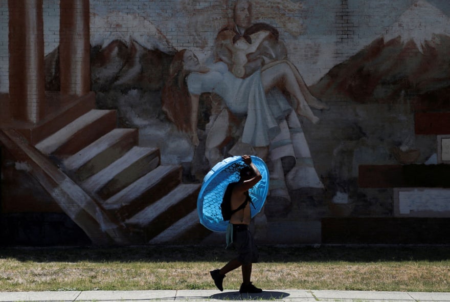 Daniel Bosquez carries a plastic pool to his friend’s apartment, as San Antonio is under an excessive heat warning, Texas, 11 July