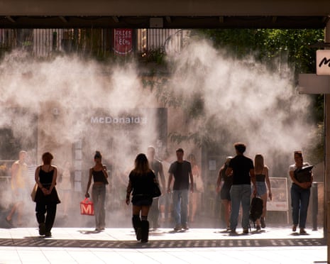 Residents walk through water mist in a shopping street as temperatures reach record highs in Bordeaux, France.