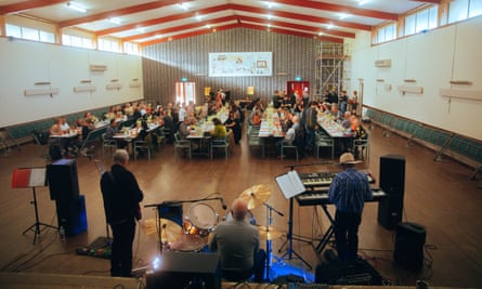Festival attendees share a dinner with Charlton locals