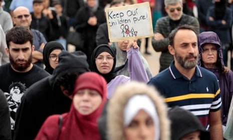 Demonstrators who support banning books gather during a protest outside of the Henry Ford Centennial library in Dearborn, Michigan, on 25 September.