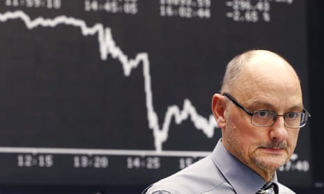 A broker in Frankfurt, Germany, watches the Dax stock index nosedive after the ECB stimulus package was announced on Thursday.