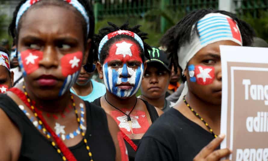 Papuan activists with faces painted in the Morning Star flag during a rally in Jakarta, Indonesia, August 2019.