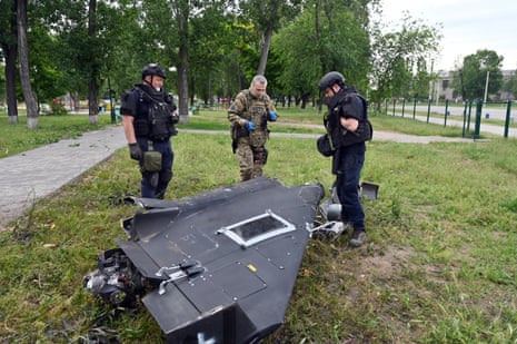 Ukrainian soldier examining downed Shahed drone components in Kharkiv region