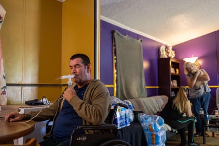 Rodney Folse breathes in medicine through a nebulizer 