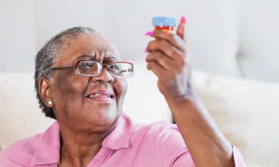 Senior African-American woman with prescription bottle