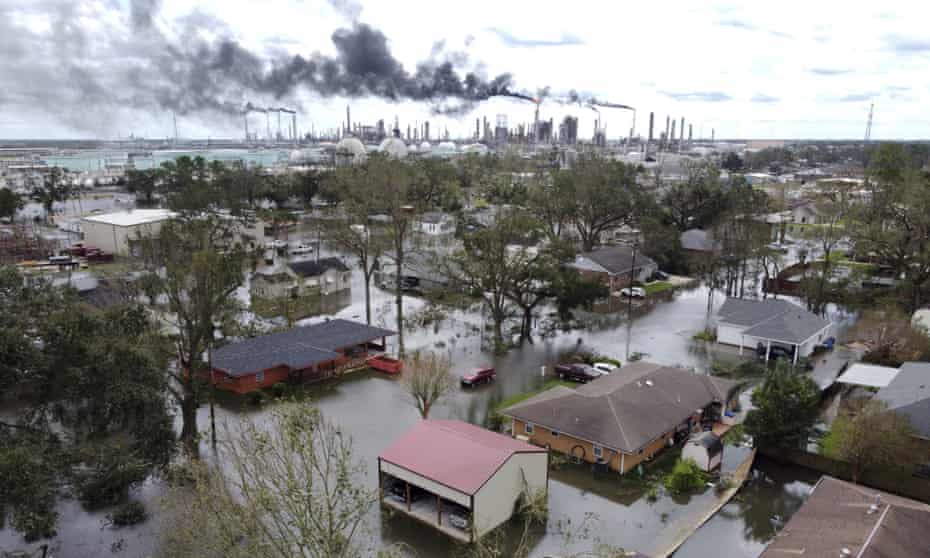 Homes near Norco, Louisiana, outside New Orleans, are surrounded by floodwater on Monday as chemical refineries continue to flare the day after Hurricane Ida hit the area.