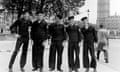 Five men in uniform stand shoulder to shoulder in front of Big Ben