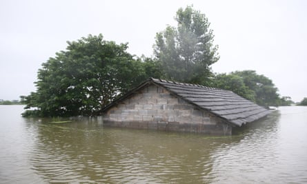 A house almost submerged in flood waters caused by heavy rain in Xuancheng city in Jiangsu province