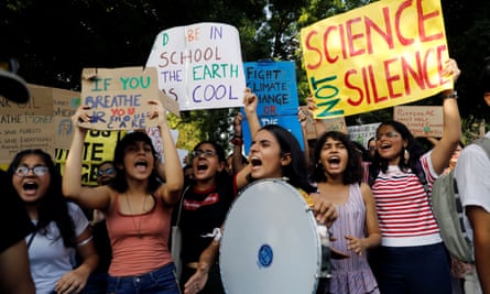 Students and activists hold placards with messages as they participate in a Global Climate Strike rally in New Delhi