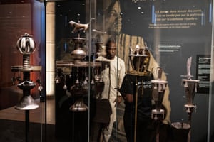 One of the first visitors to see the returned treasures wanders among the display cases