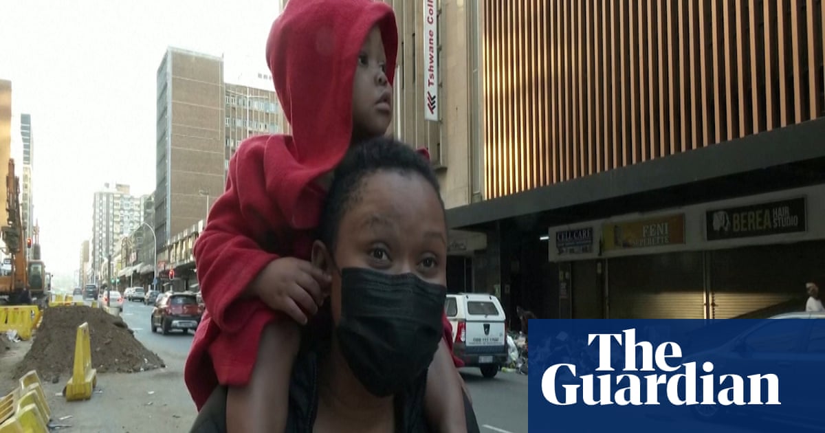South African mother describes throwing baby from burning building – video