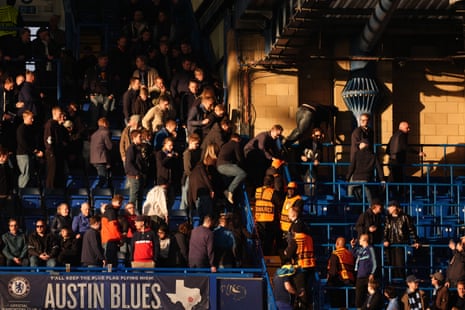 Djurgården fans jumping over barriers separating the home and away sections at Stamford Bridge