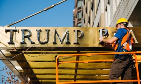 A worker takes down lettering reading ‘Trump Place’ from the facade of an apartment complex in New York on 16 November 2016.