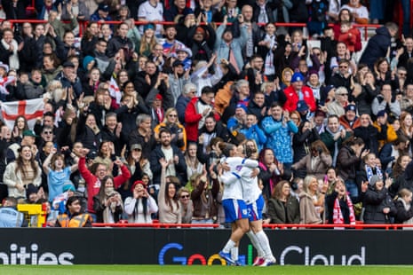 Lucy Bronze (right) celebrates scoring their first goal with Lauren James in front of joyous England fans.