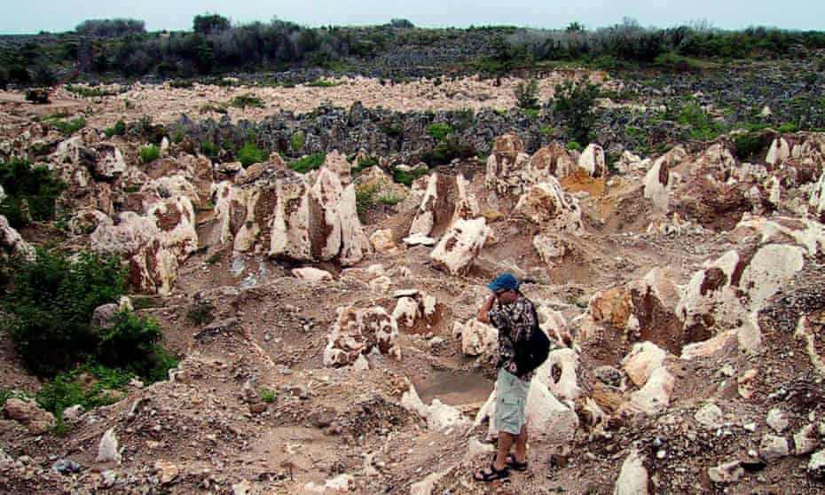 A man standing in the barren moonscape of Nauru