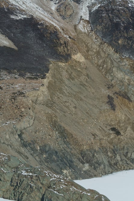 A steep mountain side descending to ice.