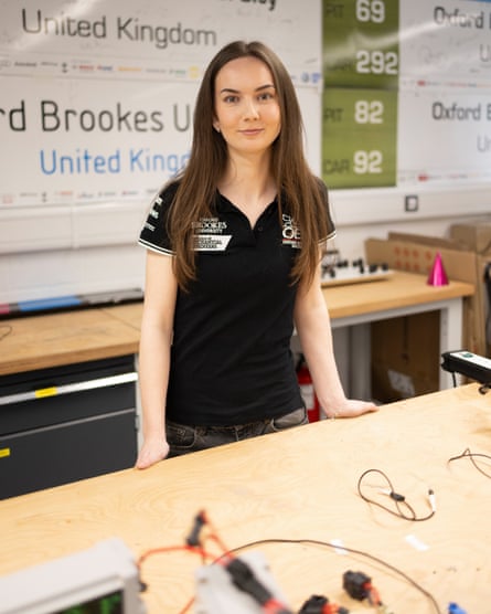 Emma Deery stands behind a workshop bench