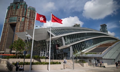 The Hong Kong and China flags outside the West Kowloon station in Hong Kong.