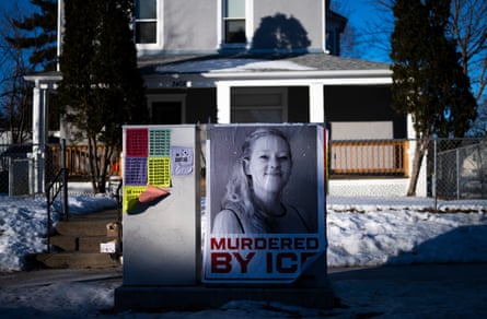 A poster that reads ‘Murdered by ICE’ under a woman’s face hangs on a box outside a home