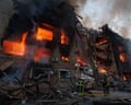 Rescue workers put out a fire in a residential building destroyed after a Russian strike on Kyiv, Ukraine, on Sunday.
