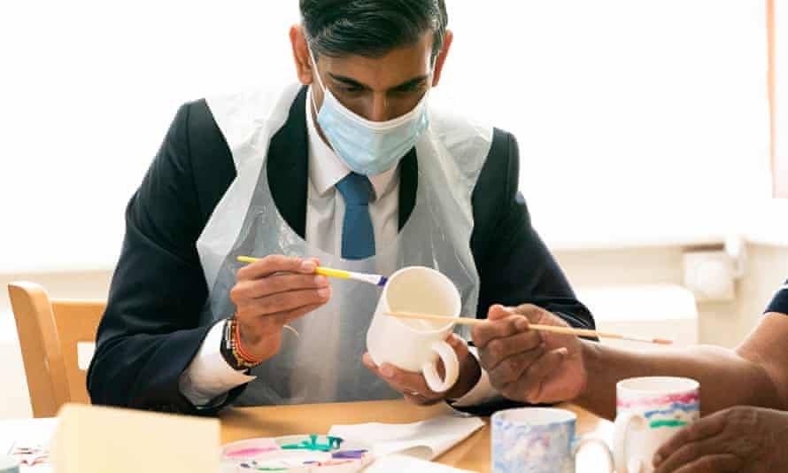 Rishi Sunak painting a mug