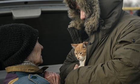 An Ukrainian serviceman holds a cat as he stands in the village of Chasiv Yar, near the city of Bachmut.