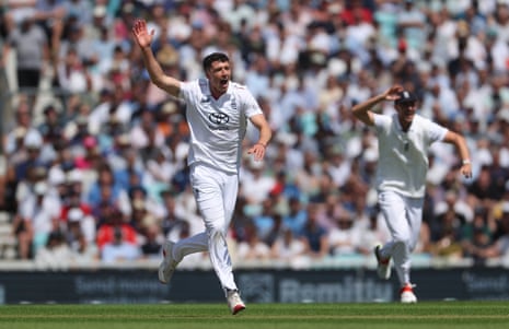 Matthew Fisher of England celebrates taking the wicket of Devon Conway.