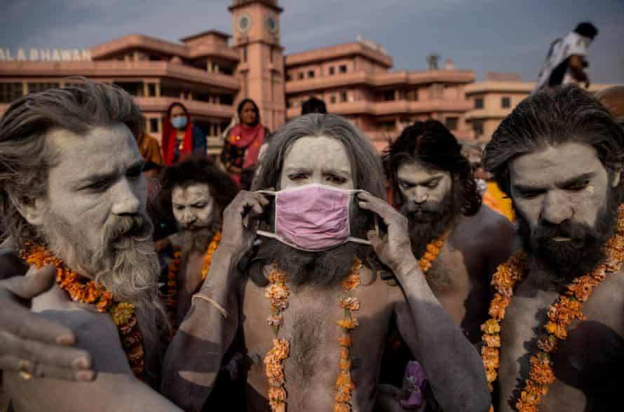 A Naga Sadhu, or Hindu holy man wears a mask before the procession for taking a dip in the Ganges river during Shahi Snan at Kumbh Mela Festival, in Haridwar, India, 12 April