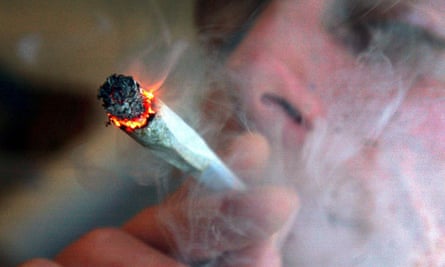 A file photo of an unidentified man smoking a cannabis cigarette