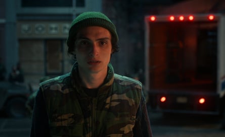 Wolfhard wearing a green beanie and a camouflage jacket