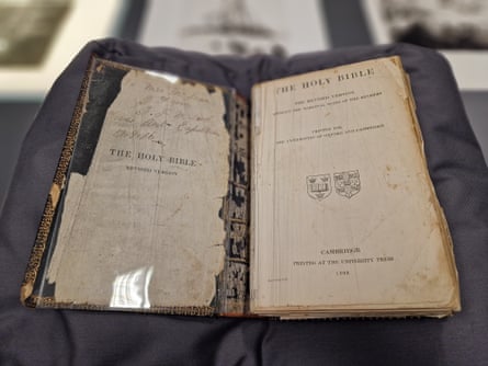 An old and damaged Bible open in a display case