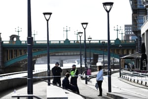 Police officers stand at a cordon near Blackfriars Bridge on the South Bank of the Thames