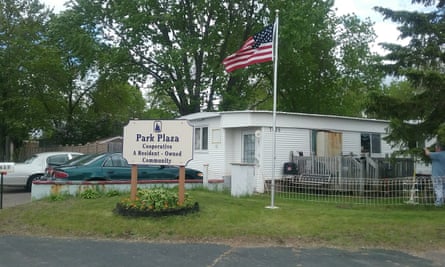 sign outside single-story building with American flag says ‘park plaza’