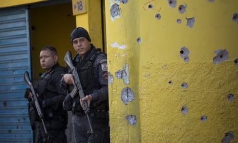 Military police stand guard in the Complexo de Alemão area of Rio de Janeiro