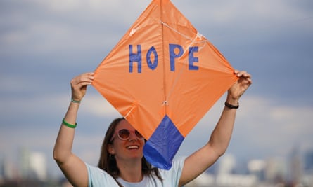 A woman with an orange kite that reads ‘Hope’.