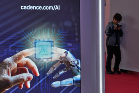 A man browses his phone near an AI booth at the China International Supply Chain Expo in Beijing in June