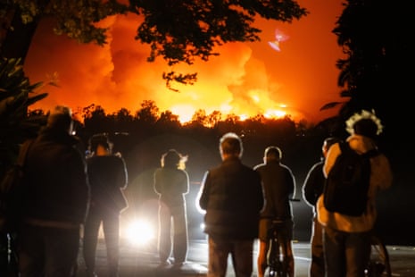 People watch the smoke and flames from the Palisades fire.
