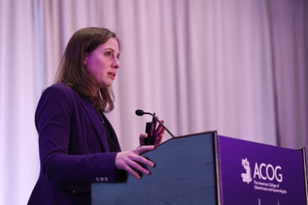 a woman speaking at a podium