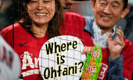 A fan wears a shirt with the face of Los Angeles Angels' Shohei