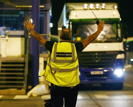 man in hi-vis vest gestures to lorry