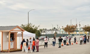 People line up at a Covid-19 testing site at The Forum on 22 December in Los Angeles, California, as the state records more than 5 million coronavirus infections.
