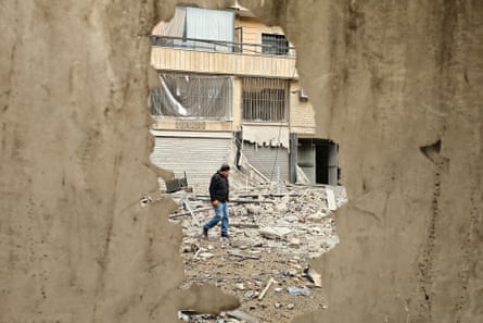 Man walking through rubble in Beirut, Lebanon