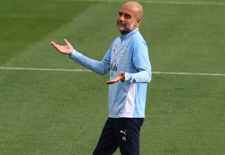 Pep Guardiola coaches Manchester City during a training session in September