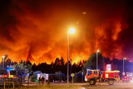 Fire engines near the smoke and flames in Le Porge